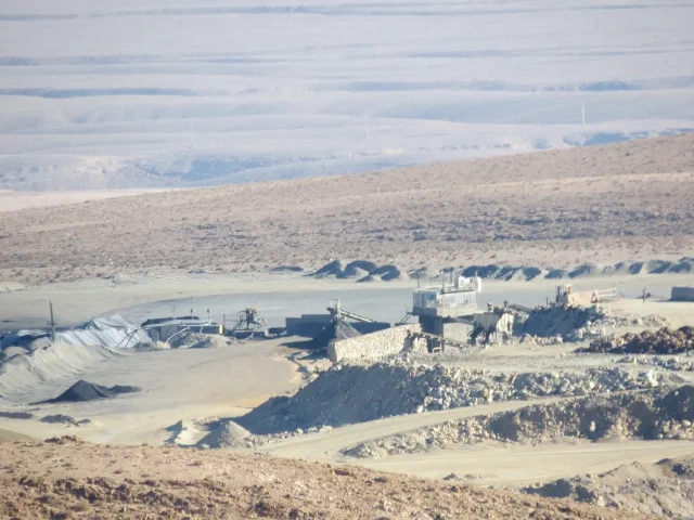 Buildings and metal structures surrounded by pale excavated ground